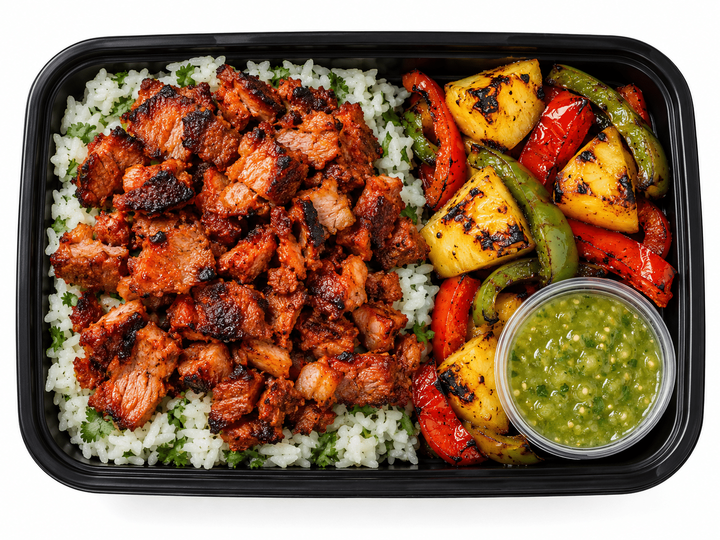 Pork Al Pastor with chopped charred pork shoulder, cilantro-lime rice, charred pineapple and peppers, and tomatillo salsa in a meal prep tray